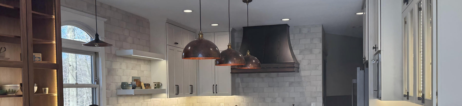 copper range hood custom curved shape in dark patina with straps and rivets at rangehoodmaster