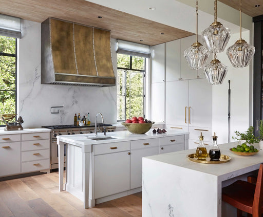 Handcrafted antique brass farmhouse range hood with stainless steel accents in a luxury kitchen