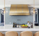 custom brushed brass ogee range hood with brushed stainless steel straps and rivets at range hood master
