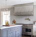 custom brushed stainless steel kitchen range hood with brushed stainless steel straps and pot rail at rangehoodmaster