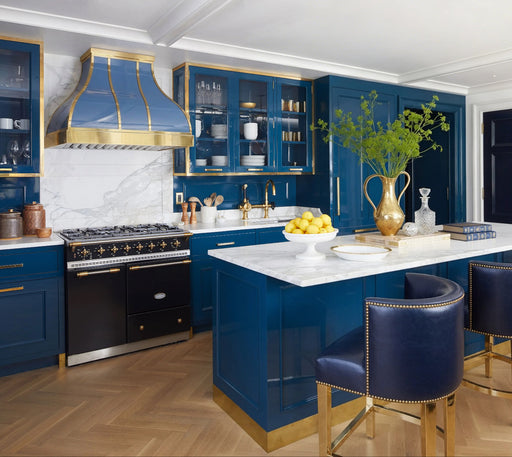 Custom California Seashore Blue range hood with polished brass trim in a luxury coastal kitchen