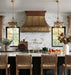 custom antique brass range hood with copper crown modling straps and rivets at rangehoodmaster