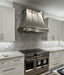 curved stainless steel range hood with mirror-like polished stainless steel straps and apron at RangeHoodMaster