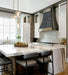 weathered blacken stainless steel custom range hoods with antique brushed brass straps and rivets modern curve shape at rangehoodmaster