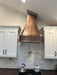 copper hood with medium copper finish and hand hammered apron, made to fit in sloping ceiling