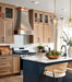 curved stainless steel range hood with light bronze straps