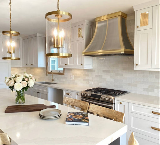 custom brushed stianless steel range hood curved shape with custom brushed brass straps and crown at rangehoodmaster