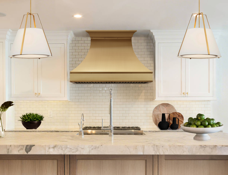 custom decorative metal range hoods in brushed brass finish with crown molding and straps at RangeHoodMaster