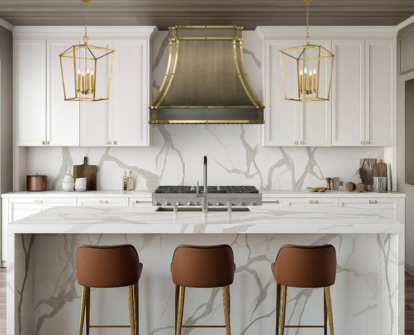 custom brass range hood in luxury brushed antique brass finish with polished brass straps and black square rivets at RangeHoodMaster