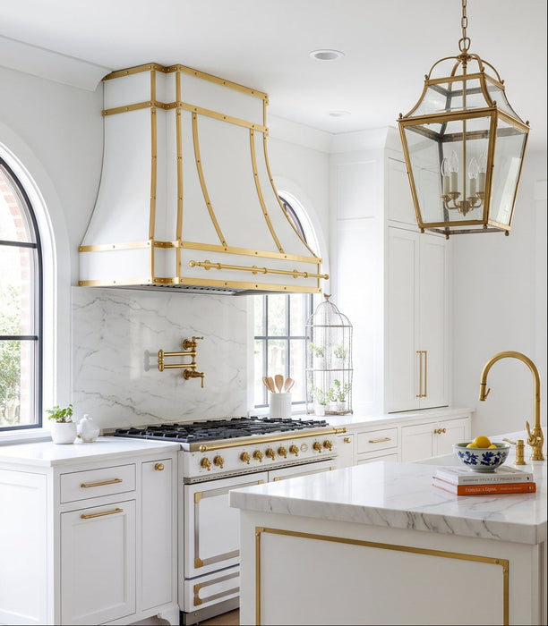 custom white modern curved stainless steel range hood with brushed brass straps and rivets and pot rail at Range Hooc Master