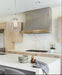Simple stainless steel range hood for modern kitchen with straps and pot rail at rangehoodmaster