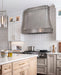 Modern curved stainless steel kitchen range hood with decorative stainless steel straps at rangehoodmaster