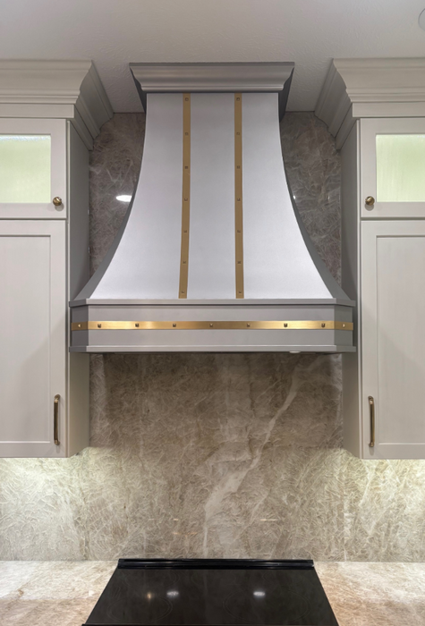 custom stainless steel range hood curved shape with brushed brass straps and square rivets