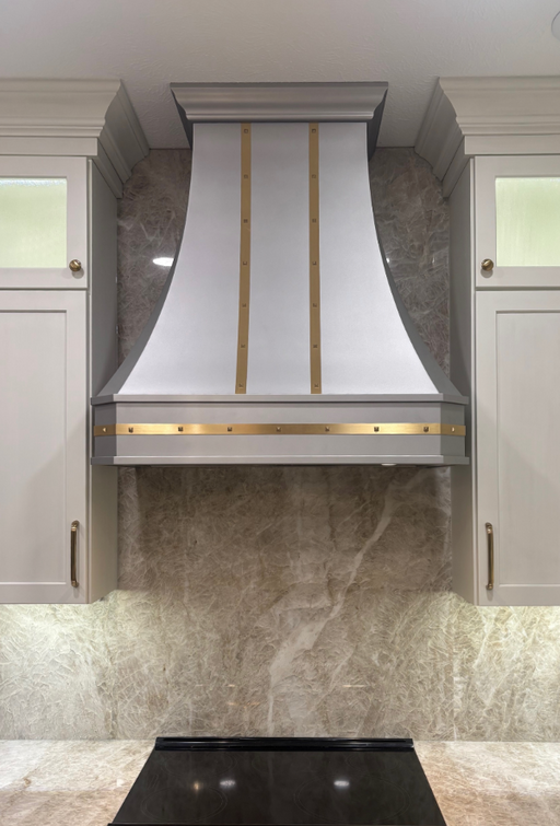 custom stainless steel range hood curved shape with brushed brass straps and square rivets