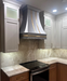 custom stainless steel range hood curved shape with brushed brass straps and square rivets