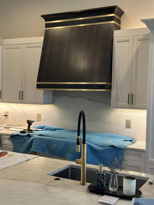 stainless steel range hood custom brushed gray with dove crown molding and brushed brass straps at RangeHoodMaster