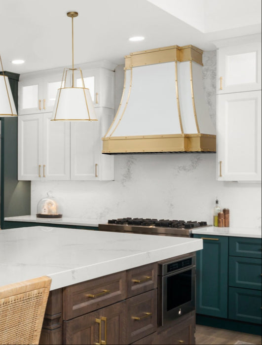 stainless steel range hood custom white painted modern curve shape with brushed brass apron and straps and rivets at RangeHoodMaster