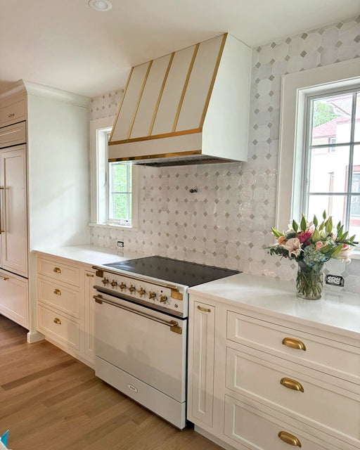 white stove hood with mirror like polished brass bands angled shape stainless steel made by rangehoodmaster