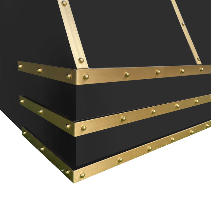 metal range hood with brass straps and rivets